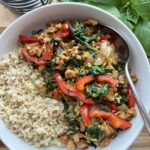 Healthy Thai basil chicken made with ground chicken, red bell peppers, garlic, and basil served with brown jasmine rice.