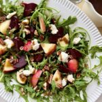 Arugula beet salad with goat cheese, apples, toasted pecans, and balsamic vinaigrette.