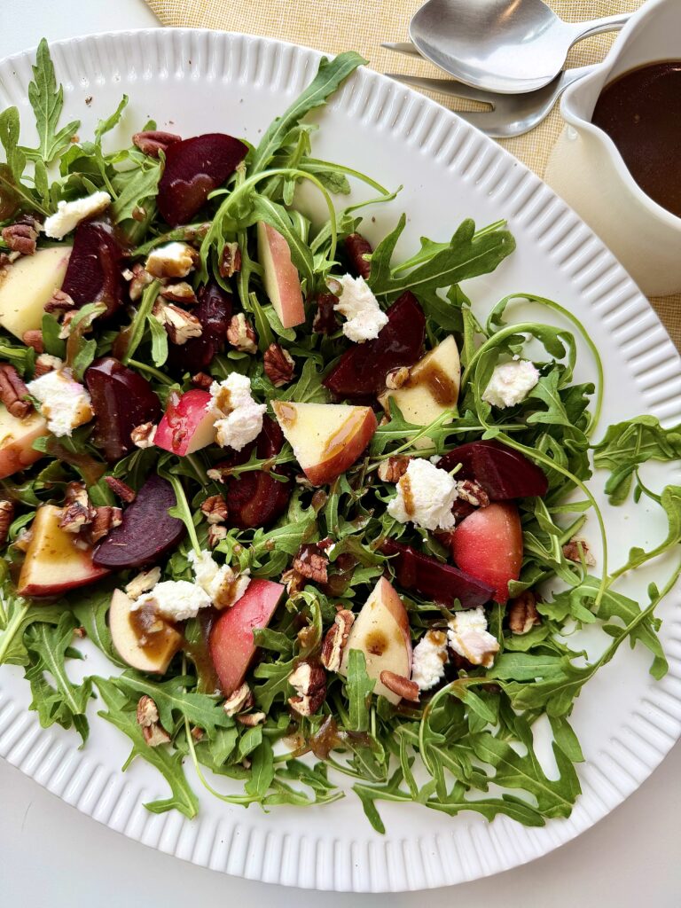 Arugula beet salad with goat cheese, apples, toasted pecans, and balsamic vinaigrette.