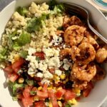 Chili-lime shrimp bowl with lime-cilantro quinoa, pico de gallo with black beans and corn, avocado, cotija, and creamy chipotle ranch