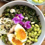 Savory oatmeal bowl with soft-boiled eggs, spinach, edamame, soy sauce, and furikake