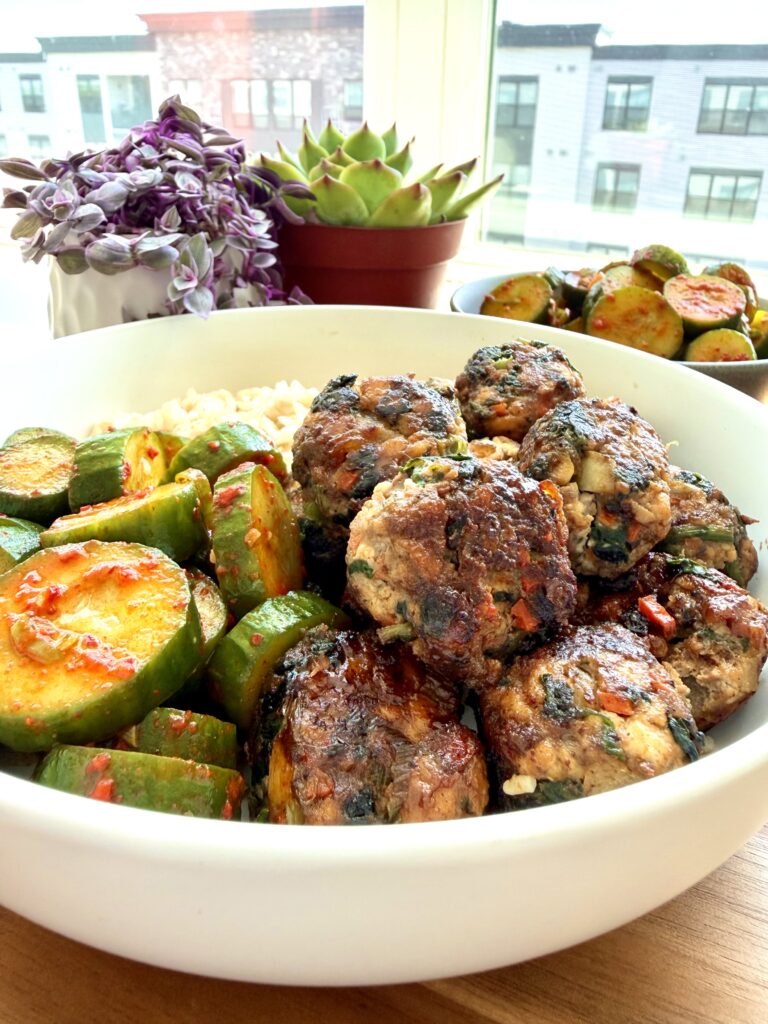 Korean Bulgogi meatballs served in a high-protein bowl with rice and cucumber salad