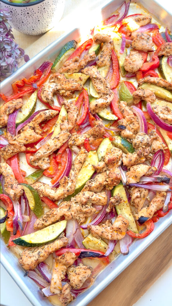 Mediterranean sheet pan chicken with roasted bell peppers, zucchini, and red onion