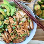 Gochujang Chicken Bowls with creamy gochujang yogurt sauce, kimchi, avocado, cucumber salad, scallions, sesame seeds, and farro.