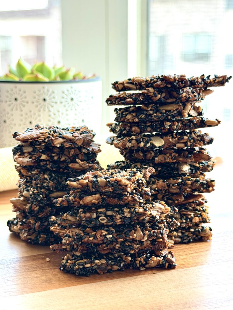 Healthy Black Sesame Seed Crackers made with black sesame seeds, pistachios, pumpkin seeds, sunflower seeds, hemp hearts, flaxseed, and chia seeds.