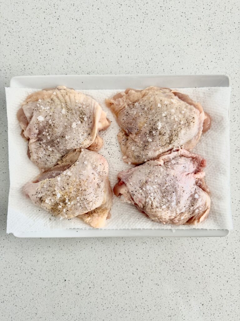 Bone-in, skin-on chicken thighs patted dry and seasoned with salt and pepper for ginger turmeric chicken soup
